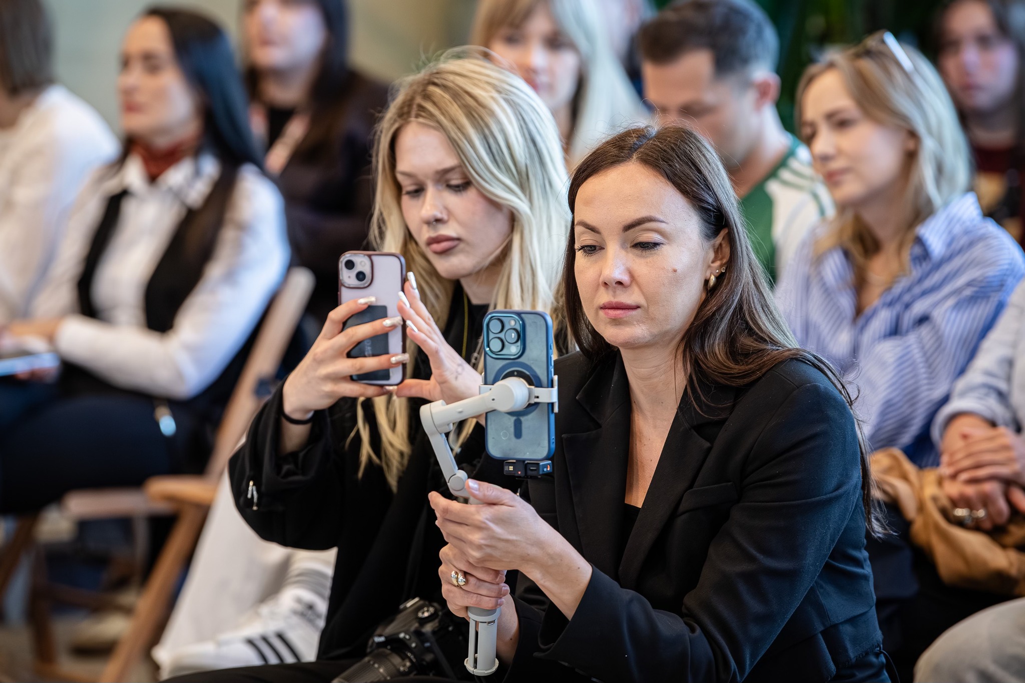 Kobiety z kom&oacute;rkami w rękach na spotkaniu z filmowcami