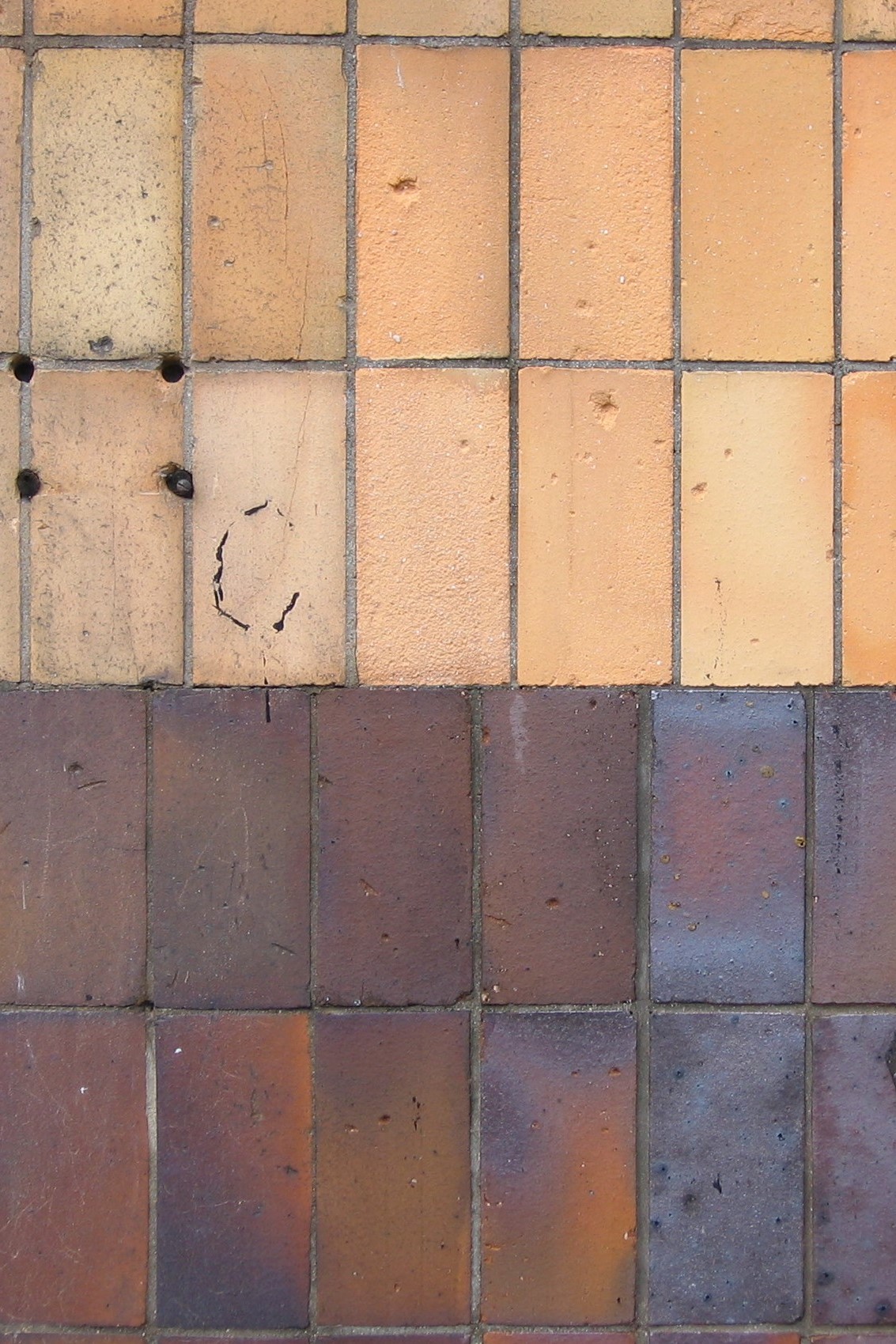 Zestawienie płytek ż&oacute;łtych i brązowych na elewacji jednej z willi